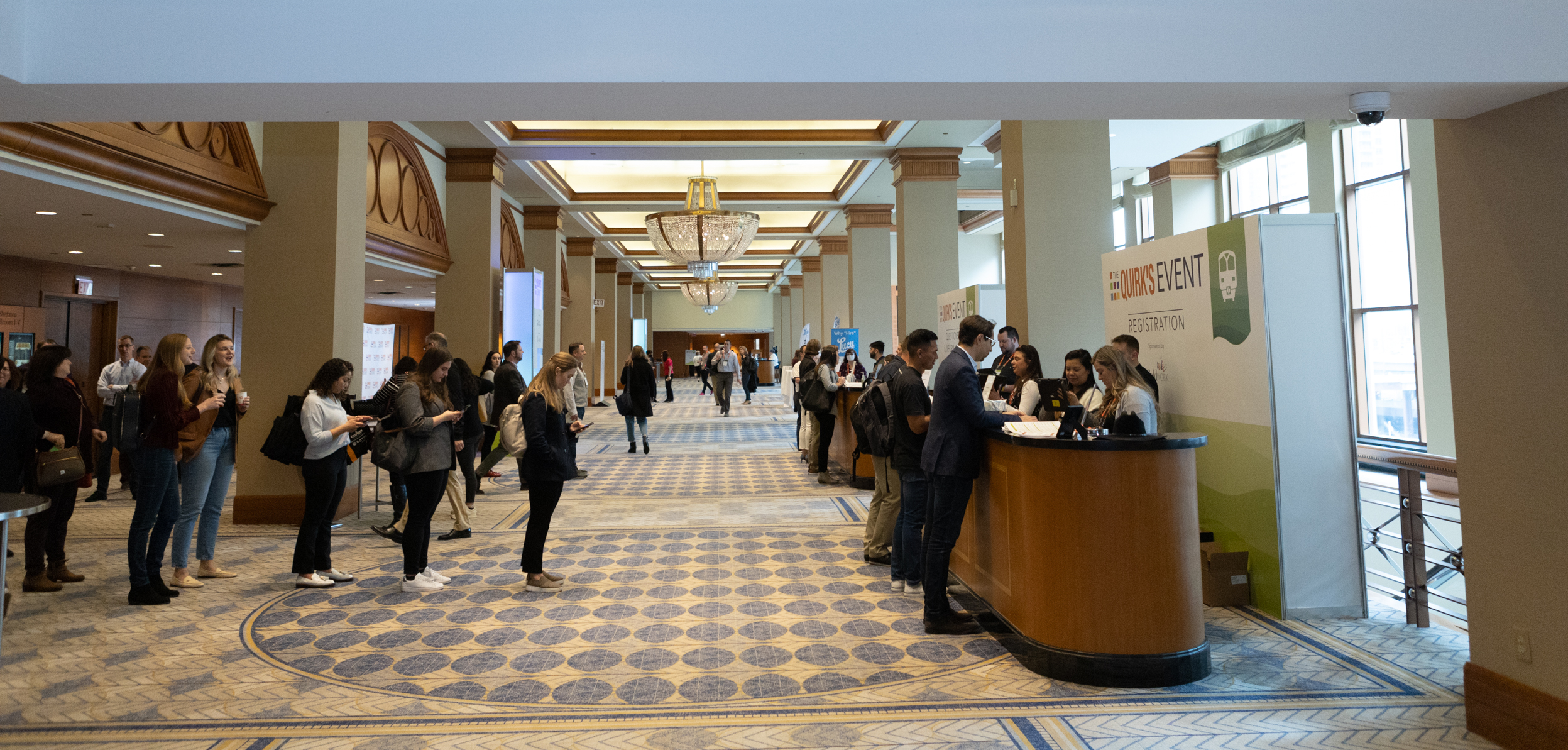 Registration desk with people lined up to register at Quirk's Chicago Event