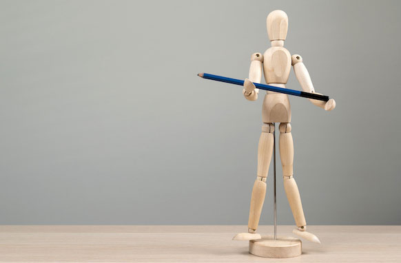 A wooden figure holding a blue color pencil.