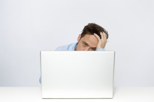 irritated man on laptop