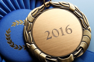Gold Medal Engraved With 2016 Resting On Blue Ribbon
