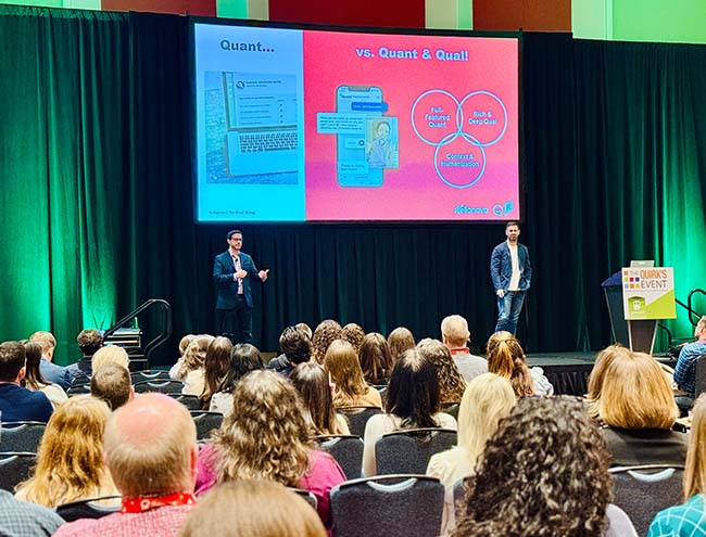 An image of Jonathan Dore, of Reach3 Insights, and Scott Healy, of Cheez-It, Kellanova, speaking during their session with their slideshow behind her at Quirk’s Event – Chicago.
