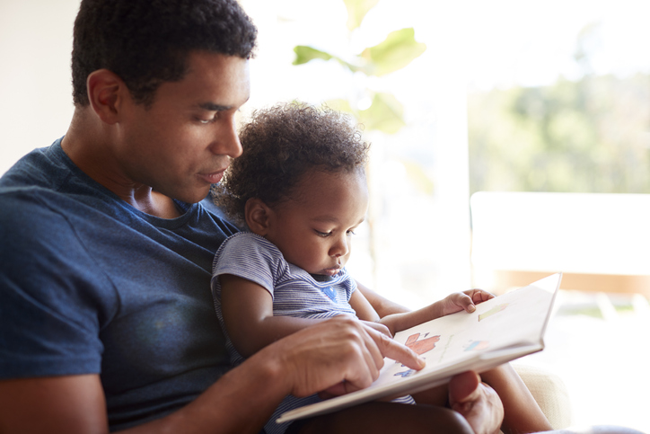 Dad reading to son