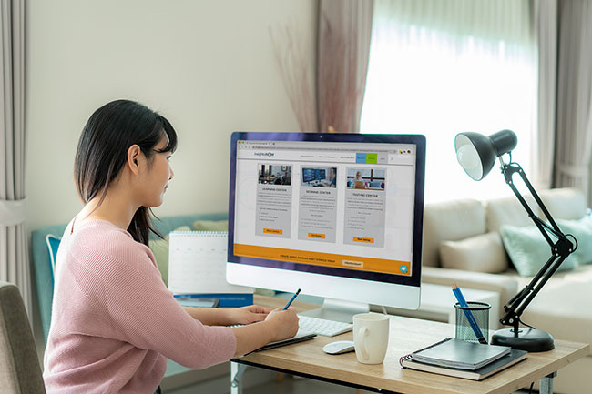 Woman using DIY qualitative research tools on desktop computer 