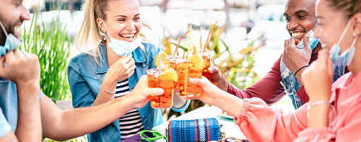 people going out to restaurants as a group holding summer drinks