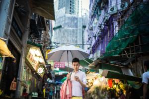 person texting on a busy street